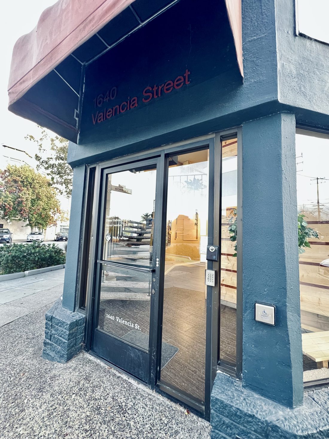 The glass entrance door marked 1640 Valencia St., with a keypad and door buzzer beside it